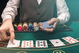 Live croupier spinning roulette wheel with lightning strike visual effects on opal slot